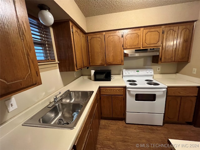 kitchen featuring dark wood-type flooring, a textured ceiling, white range with electric stovetop, and sink