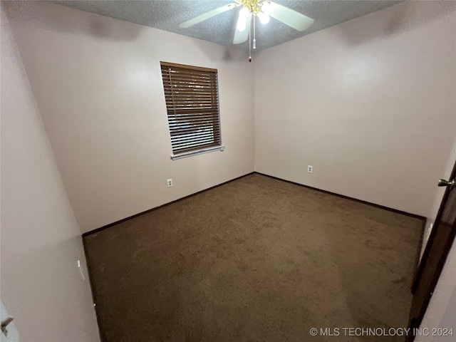 carpeted empty room featuring a textured ceiling and ceiling fan