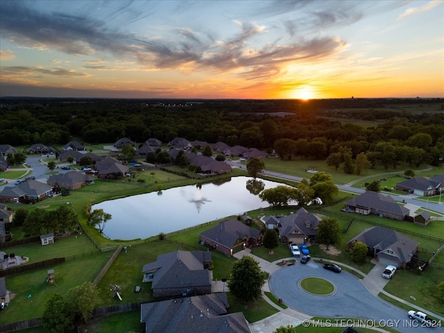 aerial view at dusk with a water view