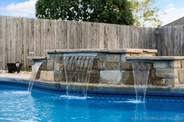 view of pool with pool water feature