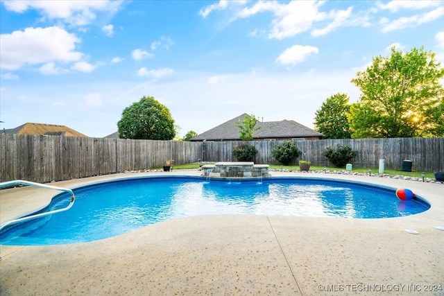 view of pool featuring pool water feature, a hot tub, and a patio area