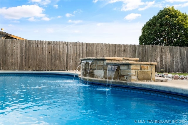 view of swimming pool featuring pool water feature