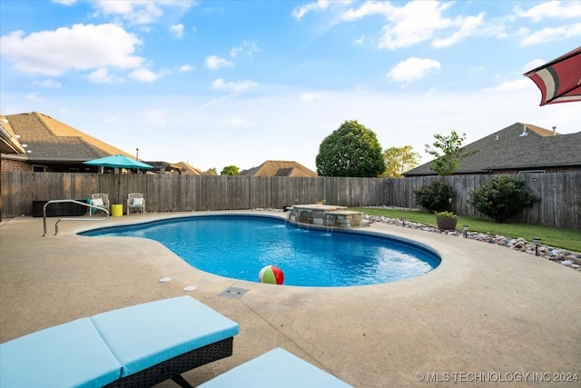 view of swimming pool with a patio, a hot tub, and pool water feature