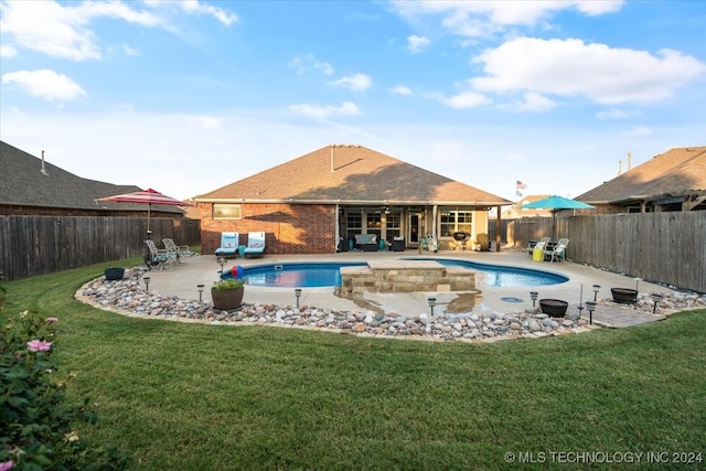 view of swimming pool featuring a lawn and a patio area