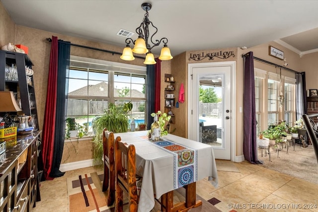 dining area with a notable chandelier, crown molding, light tile patterned floors, and a healthy amount of sunlight