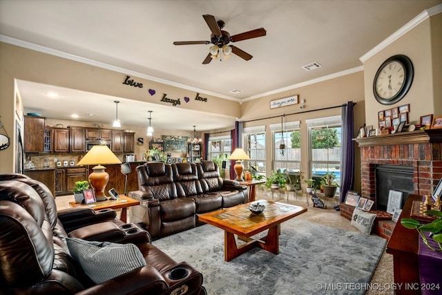 living room featuring ornamental molding, a brick fireplace, ceiling fan, and carpet flooring