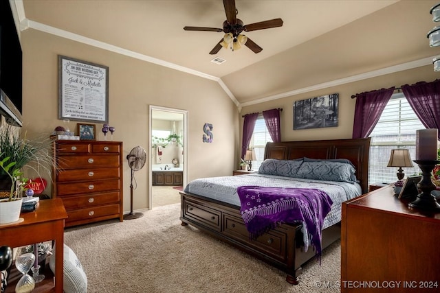 bedroom featuring multiple windows, vaulted ceiling, ensuite bath, and ceiling fan