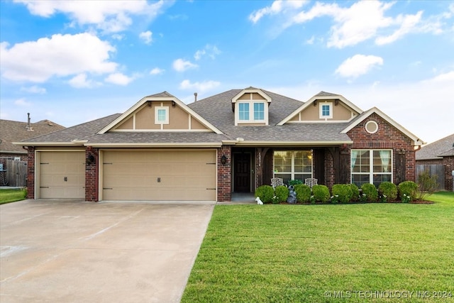 view of front of property with a front yard and a garage