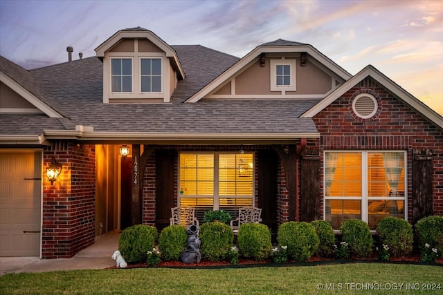 view of front of property featuring a garage and a yard