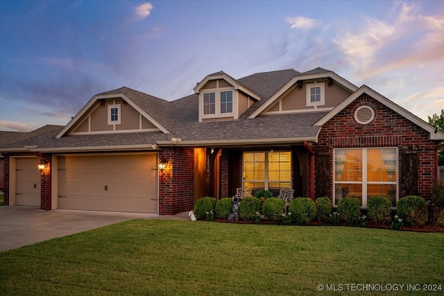 view of front of property with a lawn and a garage