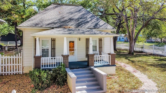 bungalow-style house with a porch and a front lawn