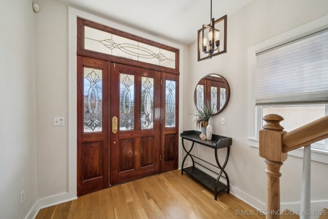 unfurnished living room with crown molding, wood-type flooring, and an inviting chandelier