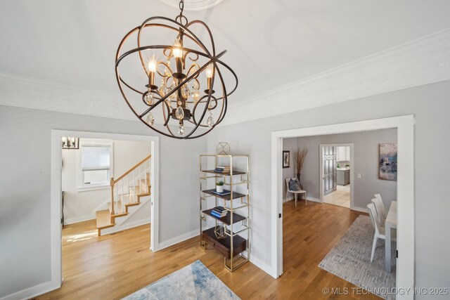 unfurnished living room with built in features, light hardwood / wood-style floors, and ceiling fan with notable chandelier