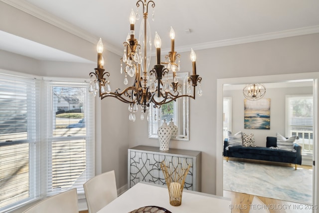 dining area featuring a chandelier, a healthy amount of sunlight, and ornamental molding