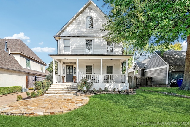 view of front of house with a porch and a front lawn