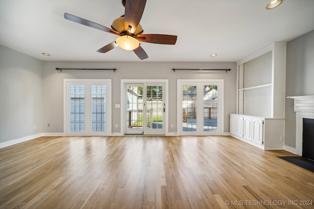 unfurnished living room with ceiling fan and light hardwood / wood-style floors