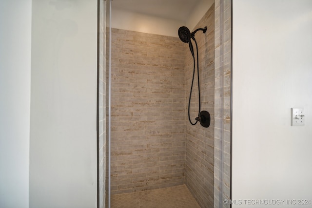 bathroom with tiled shower