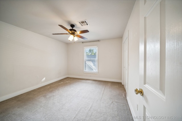 unfurnished room featuring ceiling fan and carpet floors