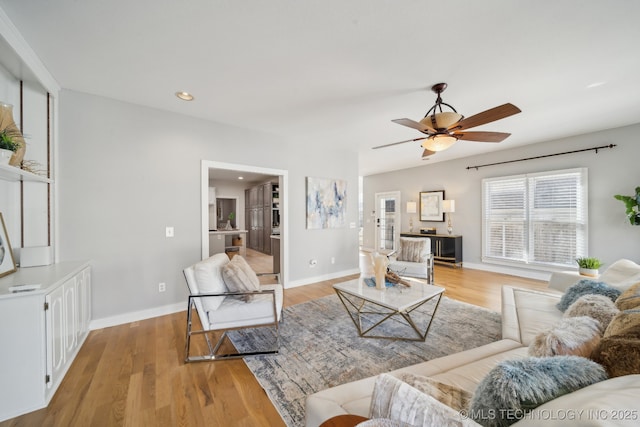 living area featuring a ceiling fan, recessed lighting, light wood-style floors, and baseboards