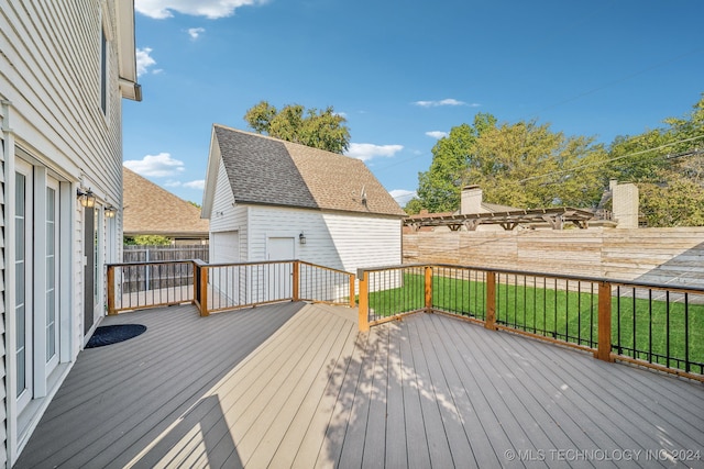 wooden deck with an outbuilding and a lawn