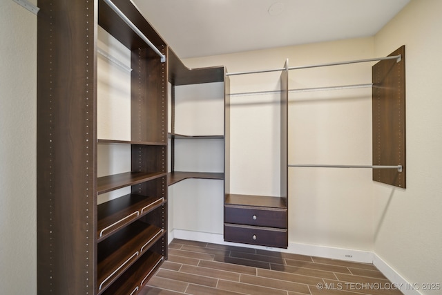 walk in closet featuring wood finish floors