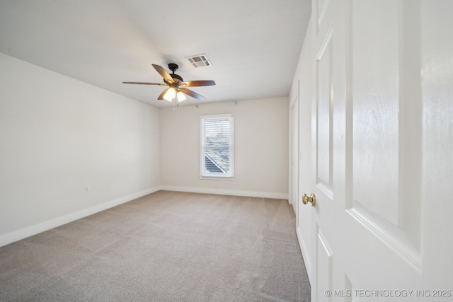 unfurnished room with baseboards, visible vents, carpet floors, and ceiling fan