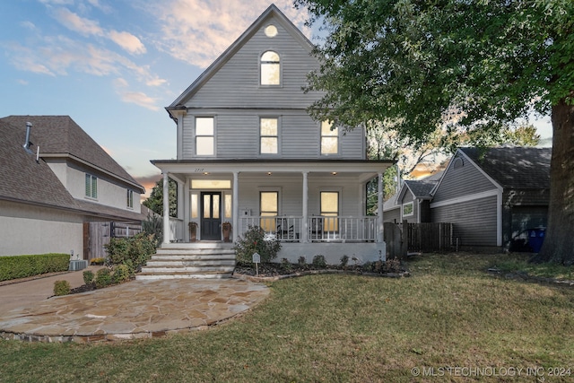 view of front of home with a yard and covered porch