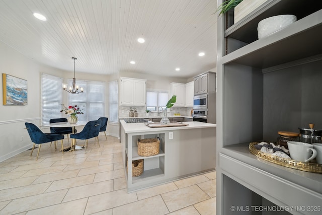 kitchen with light countertops, light tile patterned floors, decorative backsplash, stainless steel appliances, and open shelves