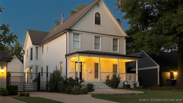 view of front of home with a porch and a gate