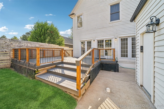 wooden deck with a yard and fence