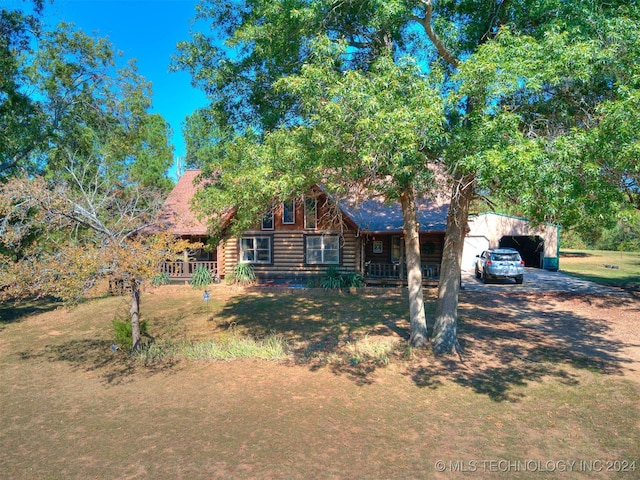 log cabin with a front lawn and a garage