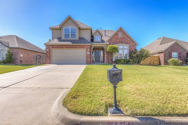 view of front of property with a front yard and a garage