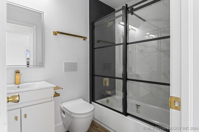 full bathroom featuring shower / bath combination with glass door, vanity, and toilet