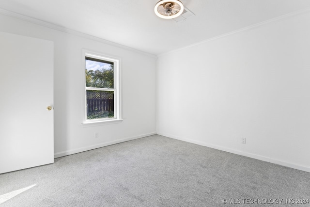 carpeted spare room with ornamental molding