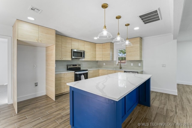 kitchen with appliances with stainless steel finishes, light brown cabinetry, a center island, decorative light fixtures, and sink