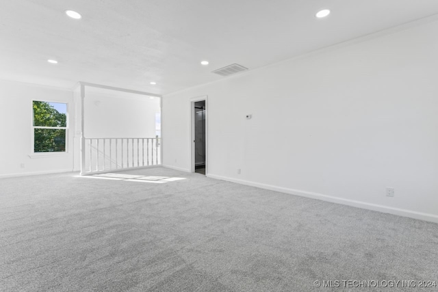 empty room with light carpet and ornamental molding