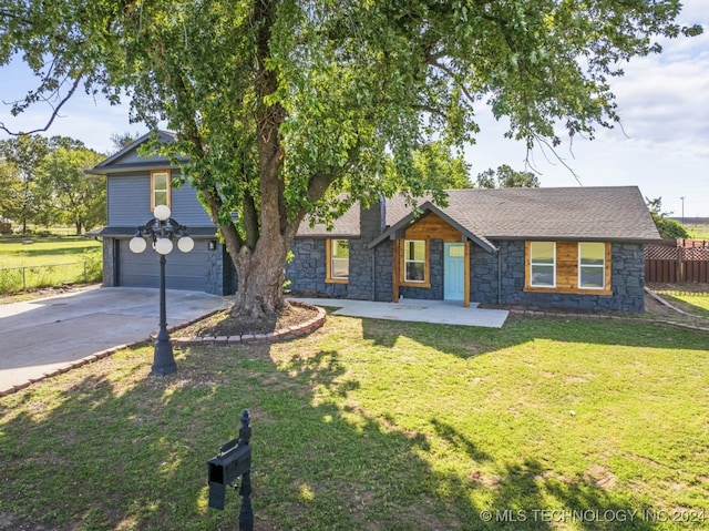 view of front of home with a garage and a front lawn