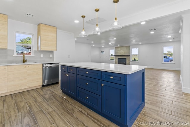 kitchen with stainless steel dishwasher, pendant lighting, dark hardwood / wood-style flooring, and blue cabinetry