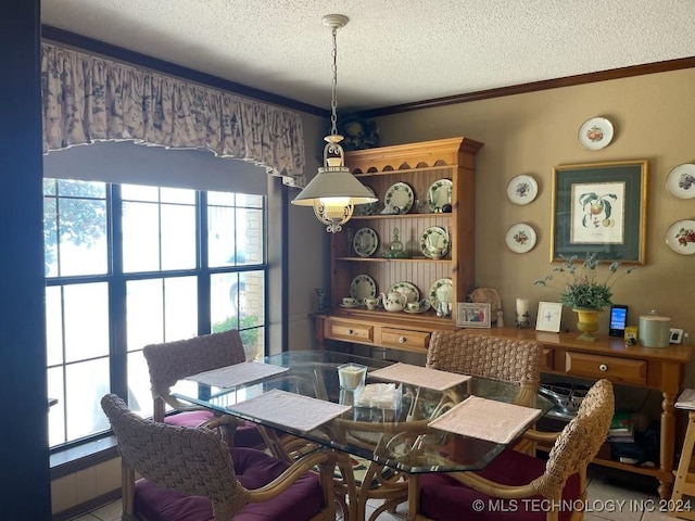 dining room with crown molding and a textured ceiling