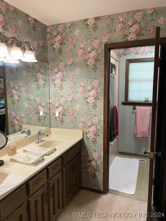 bathroom with vanity and a textured ceiling