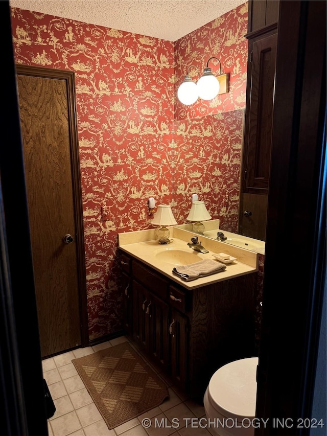 bathroom with vanity, tile patterned floors, and a textured ceiling