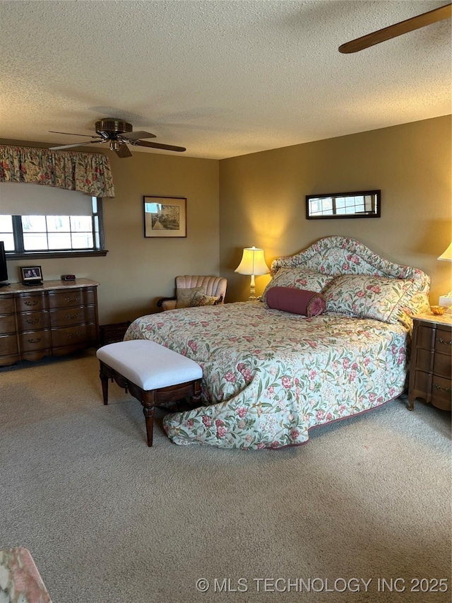 carpeted bedroom with a textured ceiling and ceiling fan