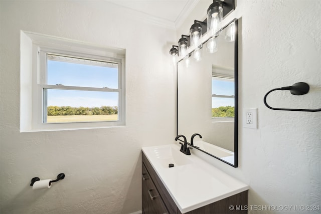 bathroom with ornamental molding and vanity