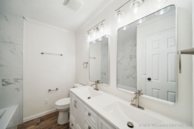 bathroom with a tub to relax in, hardwood / wood-style floors, ornamental molding, vanity, and toilet