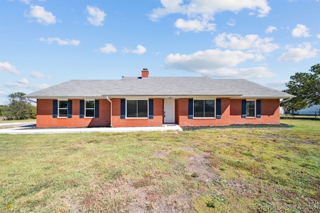 18440 County Road 3564, Ada, OK 74820 - ranch-style house featuring brick siding, a front lawn, and a chimney