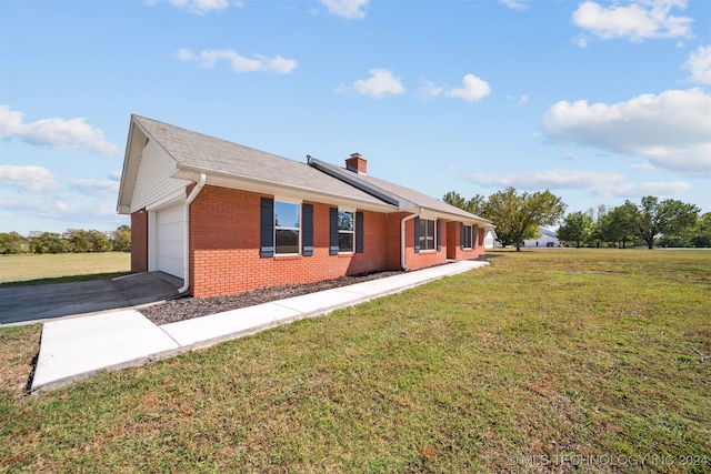 view of front of property with a front yard and a garage