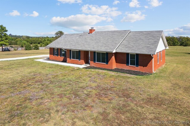 18440 County Road 3564, Ada, OK 74820 - view of front of property featuring brick siding, a front lawn, a shingled roof, and a chimney