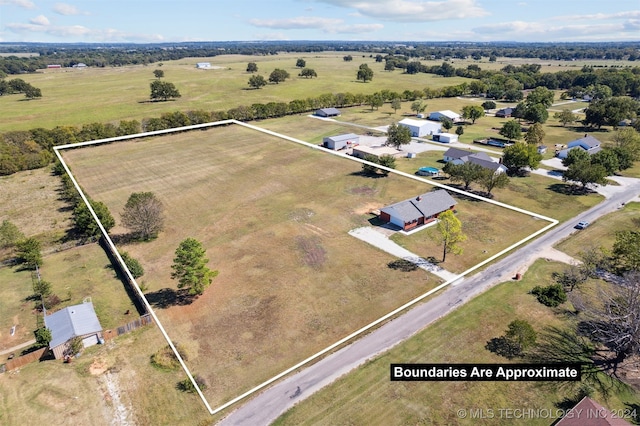 birds eye view of property with a rural view