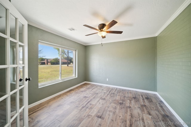 unfurnished room featuring ceiling fan, ornamental molding, a textured ceiling, and hardwood / wood-style floors