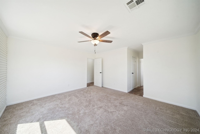 carpeted spare room with crown molding and ceiling fan